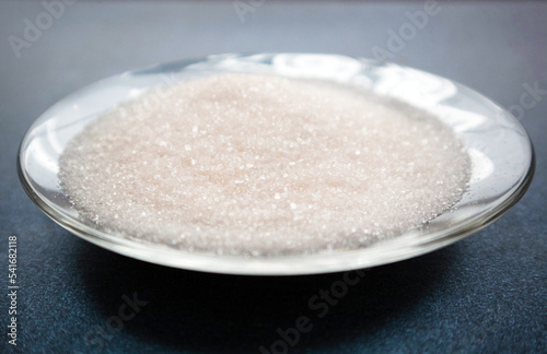 ammonium chloride sprinkled on a plate. Crystals are white. Ammonium chloride chemical concept. Photo for the product card on the site