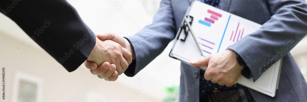 Fototapeta premium Partners shake hands, beneficial deal, successful agreement, biz partners perform friendly gesture