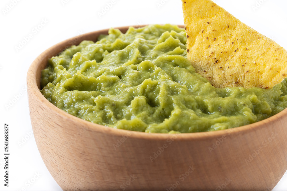 Mexican guacamole with nacho chip isolated on white background Mexican guacamole with nacho chip isolated on white background