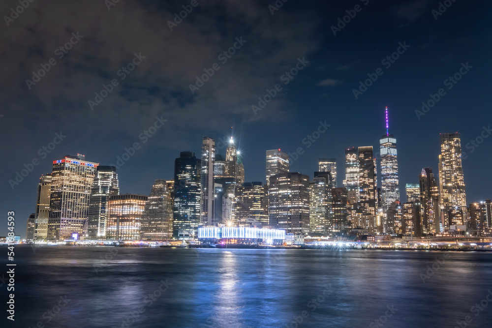 View of New York City - beautiful landscape, from Brooklyn Bridge Park, waterfront at night over bridge View of New York City - beautiful landscape, from Brooklyn Bridge Park, waterfront at night over bridge