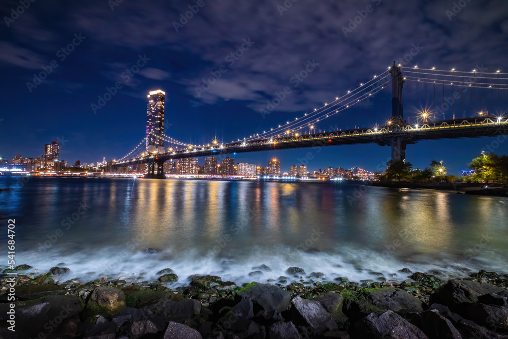 View of New York City - beautiful landscape, Manhattan Bridge, waterfront at night over bridge