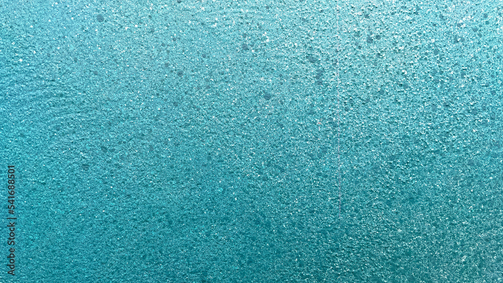 Painted Blue Gradient Textured Background. Plaster textured wall painted in a blue-white gradient and decorated with dark dots of different sizes. Beautiful horizontal detailed background.