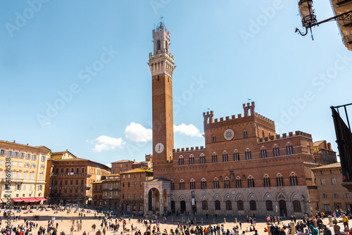 Tourists enjoy Piazza del Campo square in Siena, Italy. The historic centre of Siena has been declared by UNESCO a World Heritage Site.