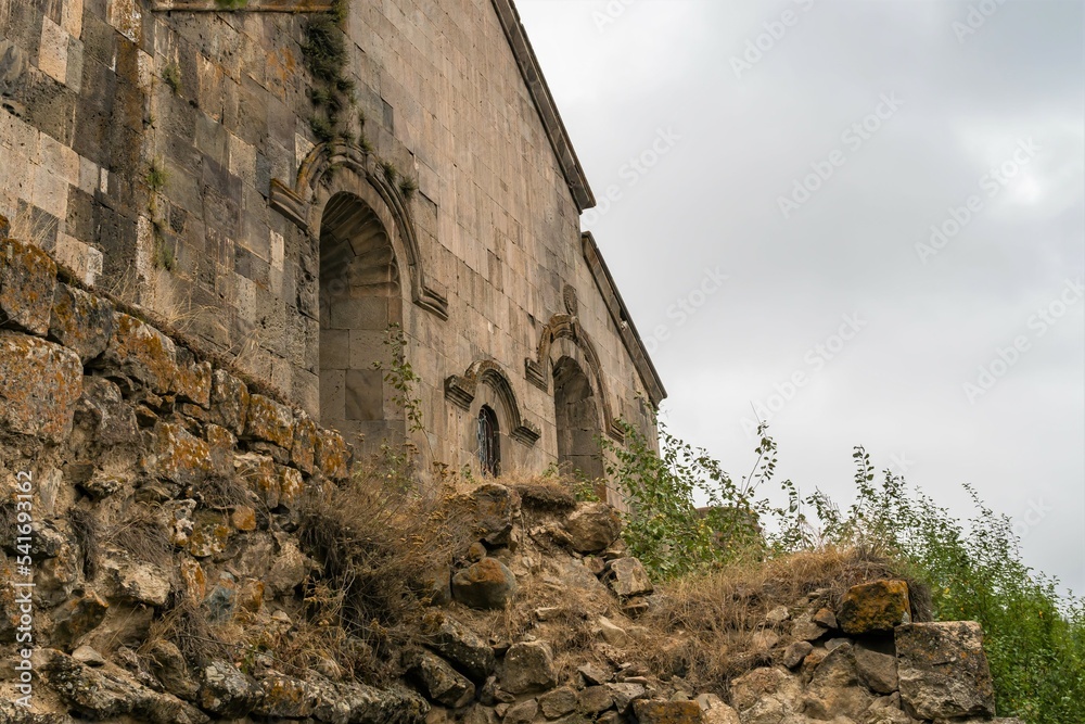 A fragment of the wall of a medieval church on a cliff in the mountains of Armenia.