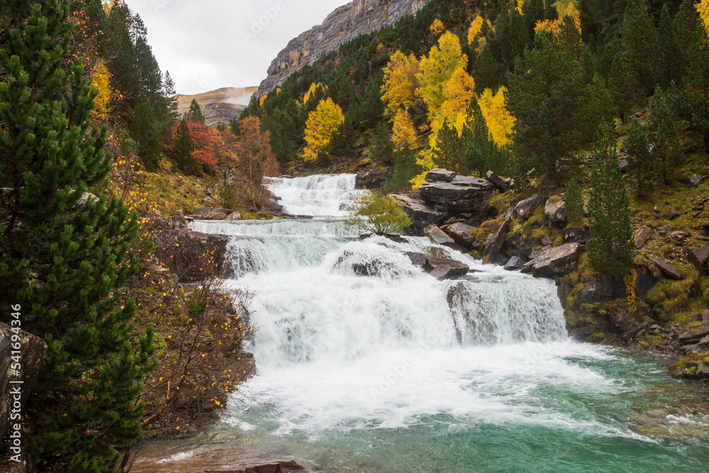 View of the Gradas de Soaso waterfall, in autumn, in the Ordesa valley, Huesca, Spain, horizontal