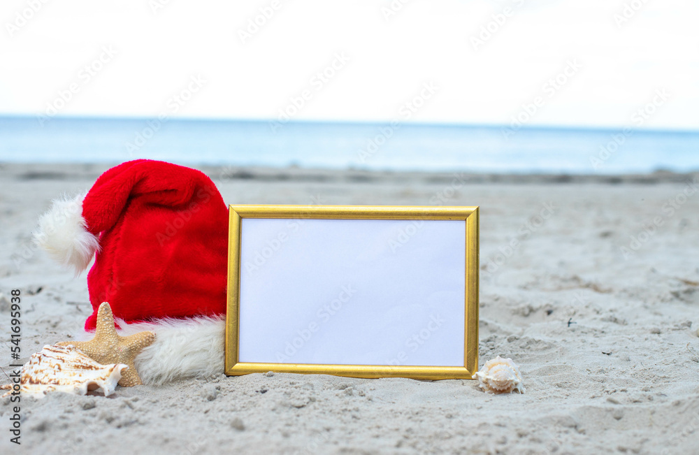 Santa Claus hat on the beach with starfish and frame rate for text