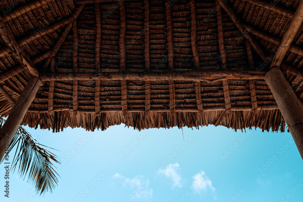 Naklejka premium Reed covered cabana roof an a tropical beach