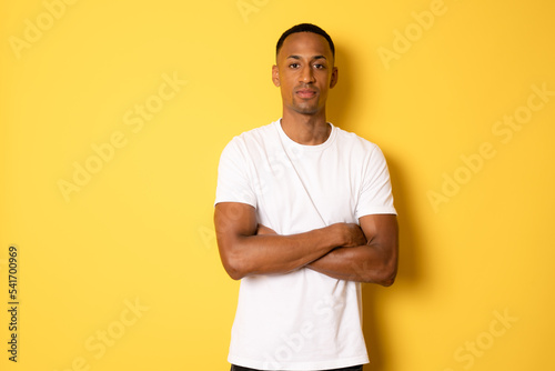 Portrait of attractive cheerful guy folded arms copy space isolated over bright yellow color background