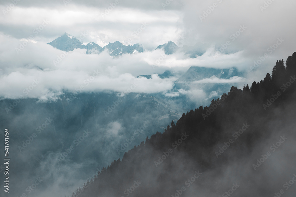 clouds over the mountains and the woods on a rainy day
