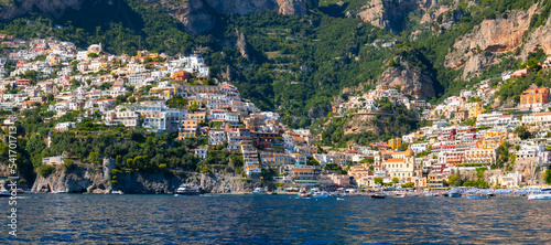 Positano wide angle panorama. Picturesque historic village on the famous Amalfi Coast in Campania Italy, world heritage area with colorful houses built on the coastline seen from tourist ferry.