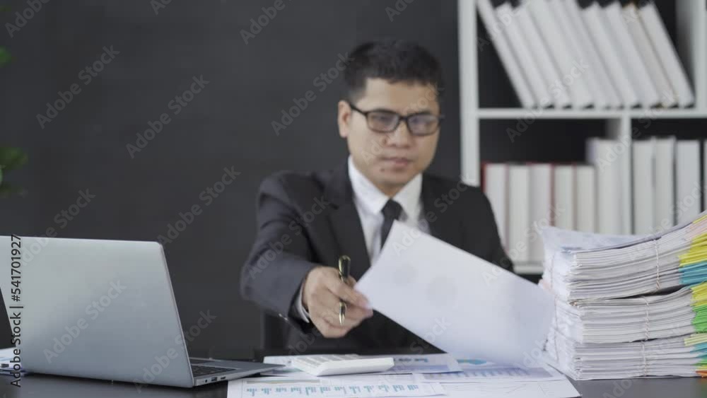 Businessman studying business documents at work writing an accountant calculating financial reporting with graph charts. finance business idea 4k 25ps Businessman studying business documents at work writing an accountant calculating financial reporting with graph charts. finance business idea 4k 25ps