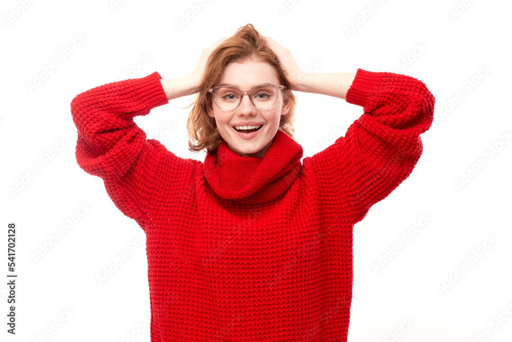 Portrait of positive redhead girl in red Christmas sweater emotionally rejoices and feels happy isolated on white background, advertising banner Portrait of positive redhead girl in red Christmas sweater emotionally rejoices and feels happy isolated on white background, advertising banner