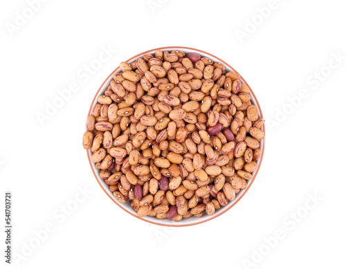 Raw borlotti beans, also known as  cranberry bean, in a ceramic bowl on white background.