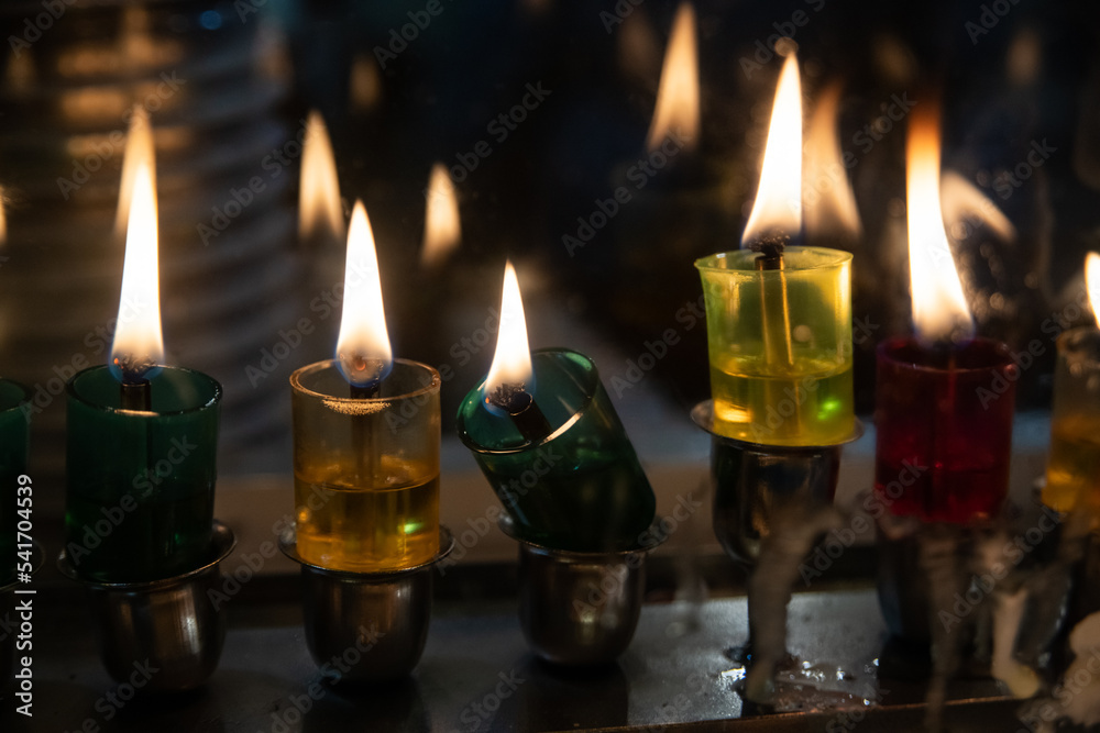 Multi-colored glass vials hold oil and wicks to light the Hanukkah menorah during the celebration of the Festival of Lights in Israel. Multi-colored glass vials hold oil and wicks to light the Hanukkah menorah during the celebration of the Festival of Lights in Israel.
