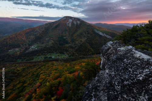 A cloudy morning on North Fork Mountain looking across towards North Creek Mountain as the rising sun illuminates the ridges of distant peaks.
