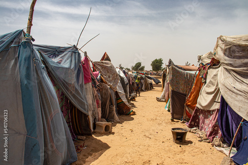 Refugee camp in Africa, full of people who took refuge due to insecurity and armed conflict. People living in very poor conditions, lack of food, clean water and proper shelter to stay in photo