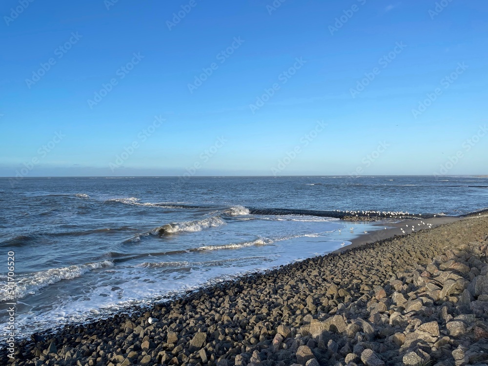 Der Westteil der Nordseeinsel Baltrum ist mit aufgeschütteten Felsen und Buhnen befestigt. Die Wellen branden dort am Abend im Herbst. Der Westteil der Nordseeinsel Baltrum ist mit aufgeschütteten Felsen und Buhnen befestigt. Die Wellen branden dort am Abend im Herbst.