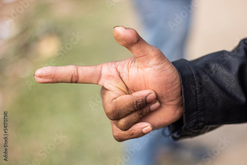 Pointing a finger like a bullet and the background blur © Rokonuzzamnan
