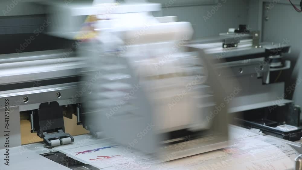Industrial printing on woven material, modern digital inkjet printer puts a picture on a cloth canvas