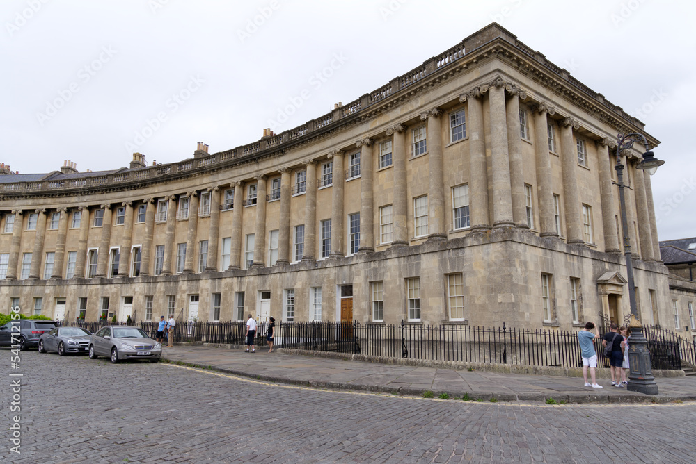 The Royal Crescent is a row of 30 terraced houses at City of Bath on a cloudy summer day. Photo taken August 2nd, 2022, Bath, United Kingdom.