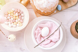 happy easter and spring holidays time. festive tablescape set decor. traditional dinner food easter eggs and baked cakes on table at home. pale pop pastel blue and pink color. top view. flare