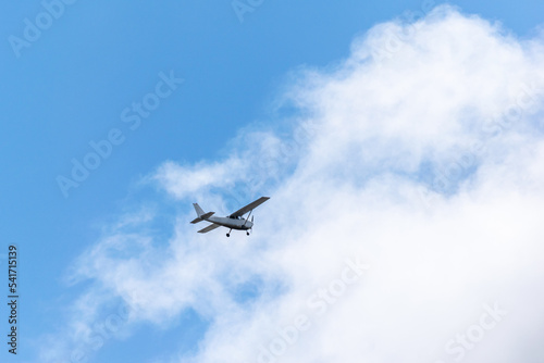 light plane flying over fluffy clouds. Air travel. the plane takes off into the sky.