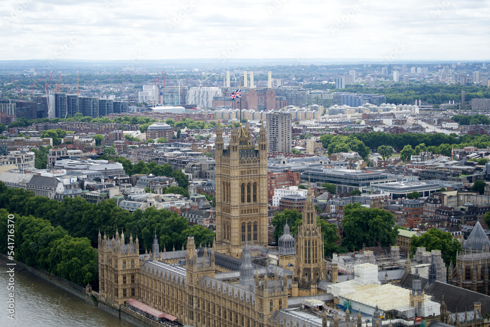 Aerial view of Westminster Palace, Westminster Abbey, Westminster Bridge and Thames River on a cloudy summer day. Photo taken August 3rd, 2022, London, England.