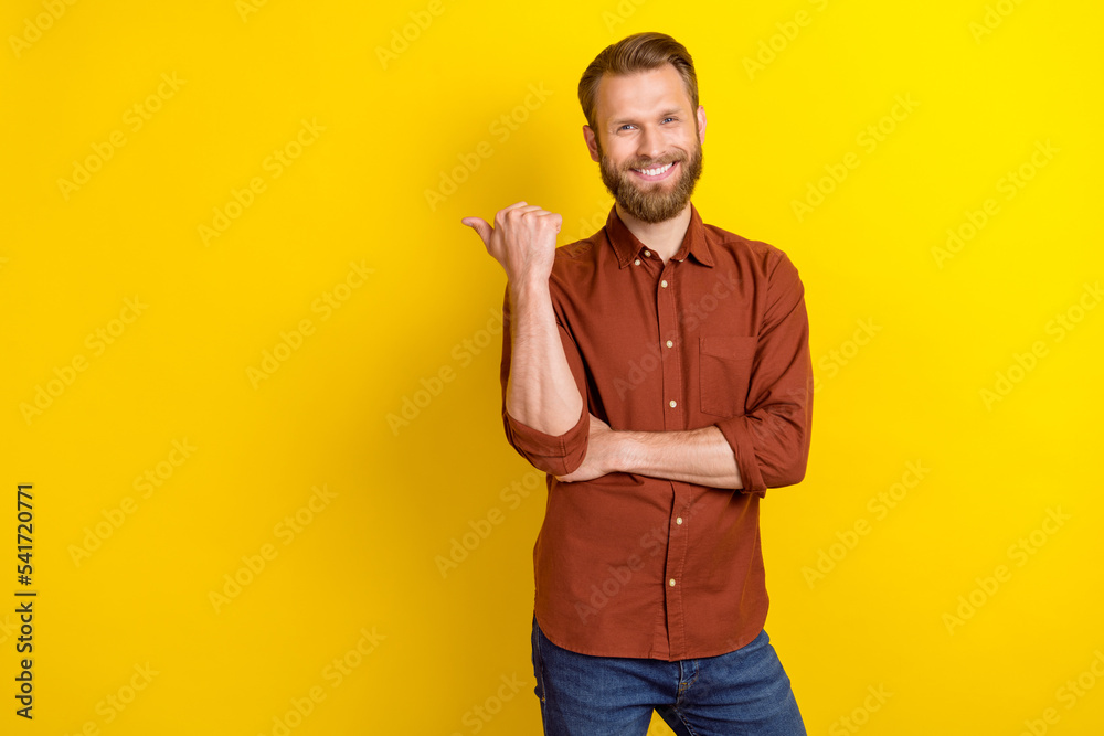 Photo of good looking men dressed trendy clothes arm direct empty space share info barbershop price isolated on yellow color background Photo of good looking men dressed trendy clothes arm direct empty space share info barbershop price isolated on yellow color background