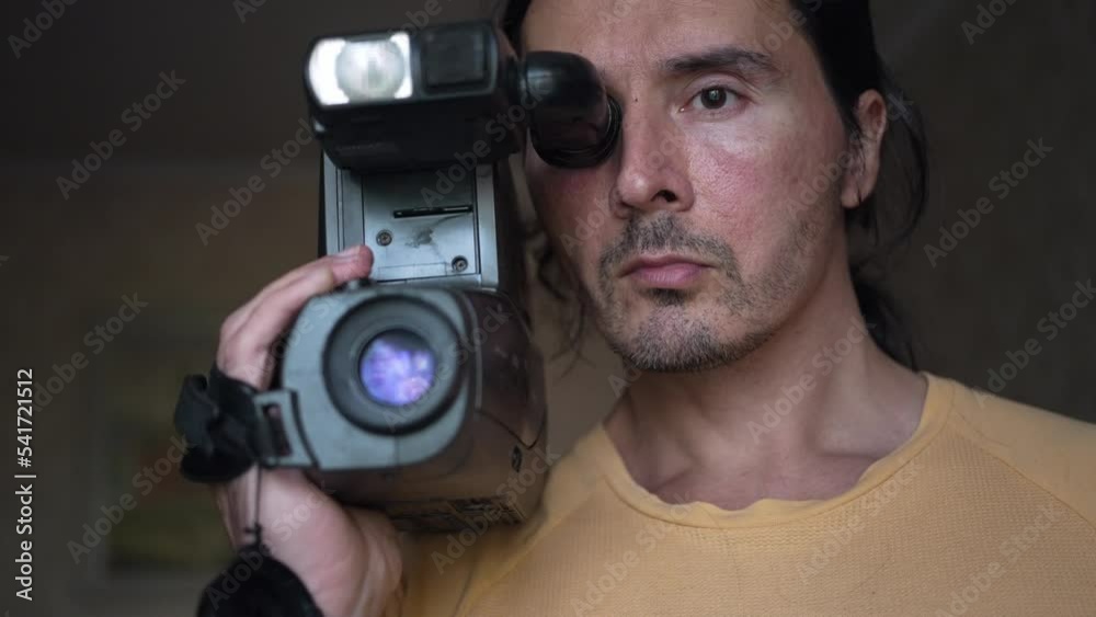 A handsome cameraman with a retro camcorder, man with camera. Slow motion A handsome cameraman with a retro camcorder, man with camera. Slow motion