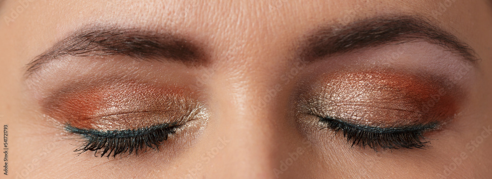 Naklejka premium Evening make-up on women's closed eyes, close-up, macro