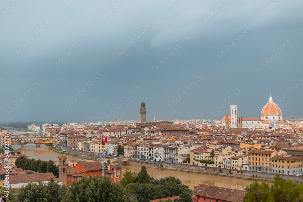 Amazing beautiful city of Florence, Italy with ancient buildings and cathedrals with river and bridge on a cloudy day