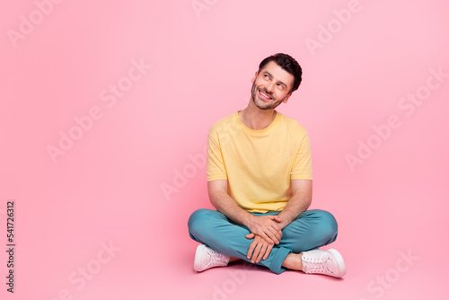 Photo of optimistic man dressed yellow trendy clothes interested look empty space dream holiday weekend isolated on pink color background © deagreez