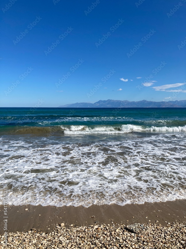 stormy sea in Acharavi, small resrt in Corfu island, Greece with Albania mountains in a distance