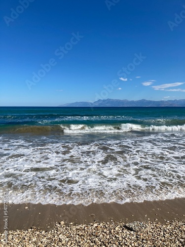 stormy sea in Acharavi, small resrt in Corfu island, Greece with Albania mountains in a distance photo