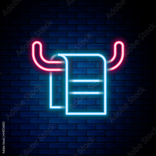 Glowing neon line Towel on a hanger icon isolated on brick wall background. Bathroom towel icon. Colorful outline concept. Vector