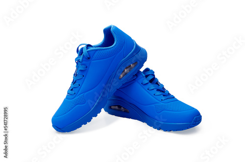 Blue sneakers on white background. Fashionable stylish leather sports casual shoes. Creative minimalistic footwear layout. Lifestyle product photo, urban style concept.