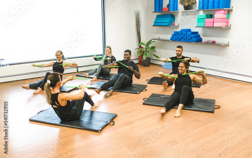Fitness Teachers with Green Drum Stick at the gym with a training group of peole photo
