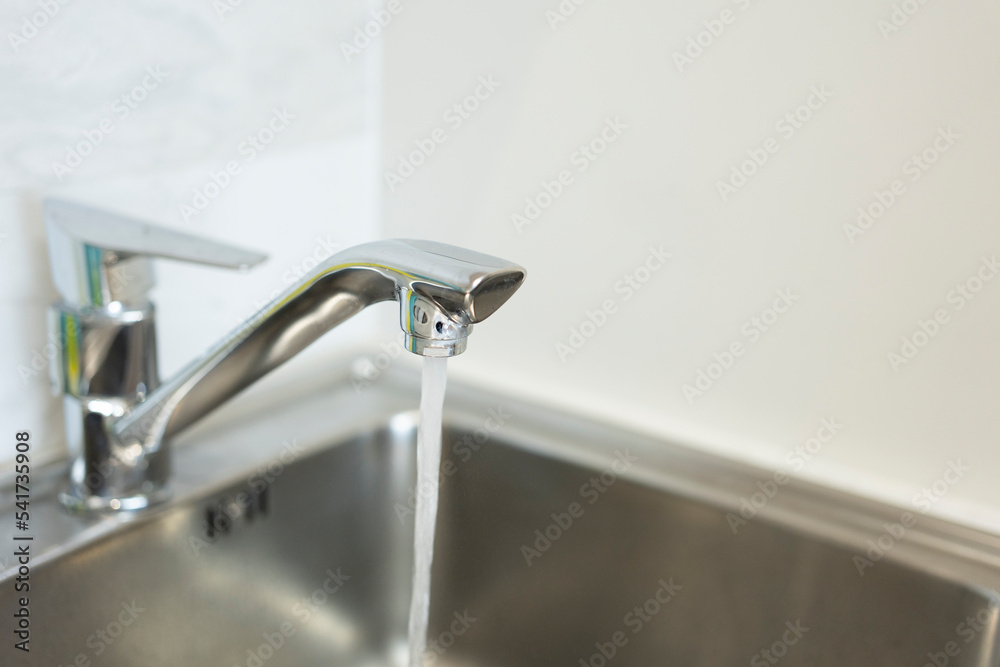 Close up water tap, flow water in bathroom with sink. Modern clean hause. Hygiene concept. Close up water tap, flow water in bathroom with sink. Modern clean hause. Hygiene concept.