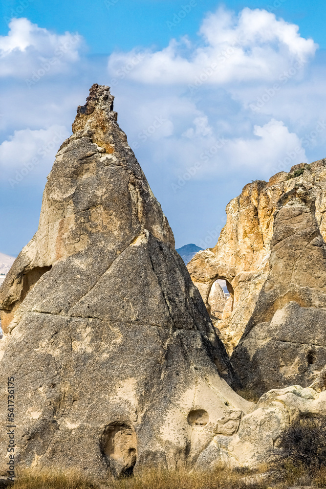 Panoramic view of cone-shaped rock formations in Selime, Turkey. Goreme is known for its fairy chimneys and eroded rock formations.