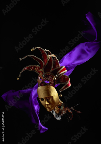 Old carnival masks with flutters purple cloth.