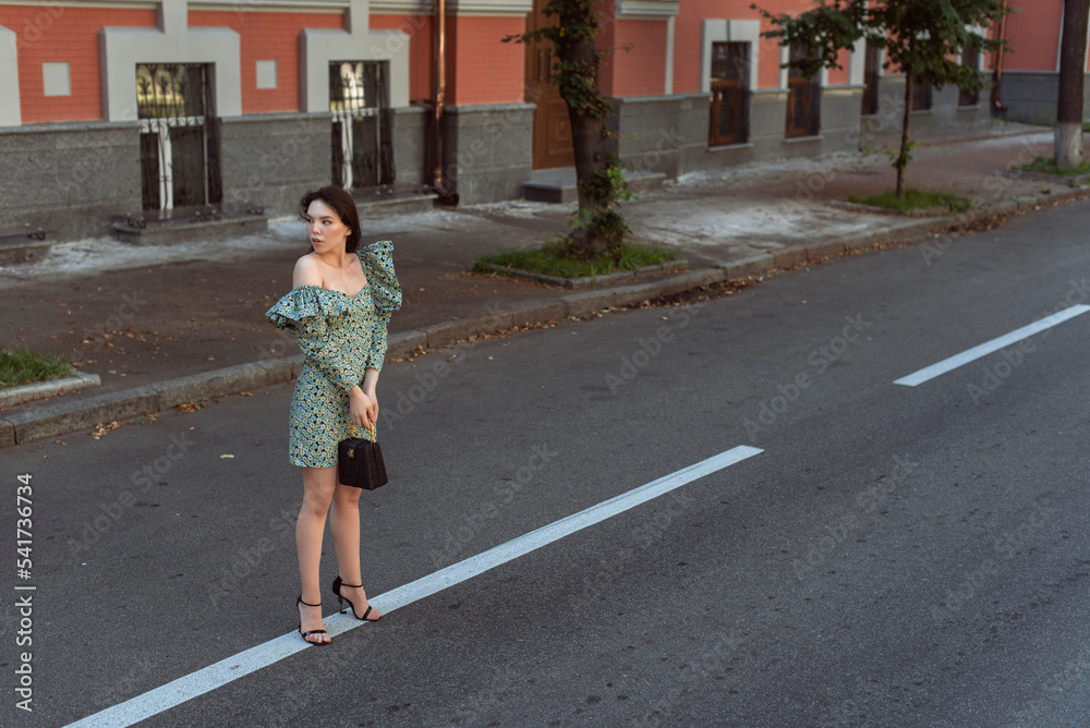 Young woman walking in summer city Young woman walking in summer city