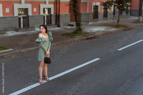 Young woman walking in summer city