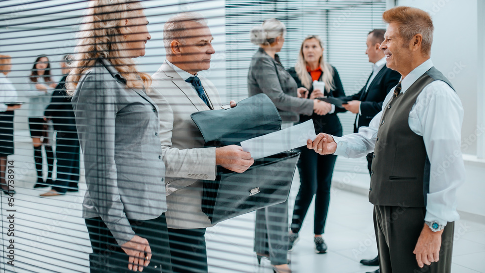 Fototapeta premium close up. successful businessman handing document to his business partner.
