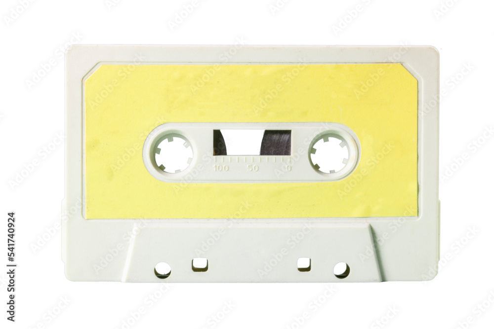 Close-up front shot: an old vintage cassette tape (obsolete music technology). Pale yellow label over a snow plastic body.
