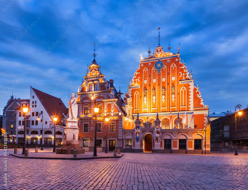 Riga Town Hall Square, House of the Blackheads and St. Roland Statue illuminated in the evening twilight, Riga, Latvia