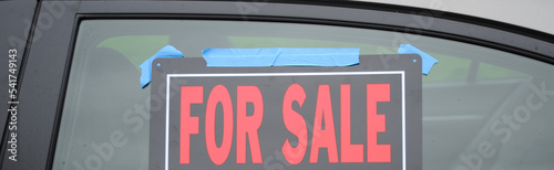 Car for sale sign on a car window.