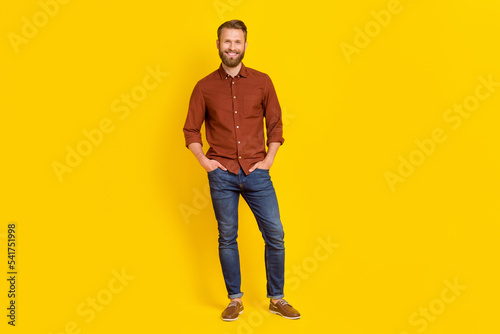 Full body photo of successful satisfied person put hands pockets posing isolated on yellow color background
