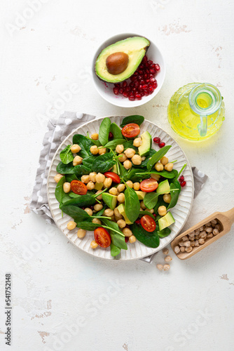 Overhead view of healthy food vegan avocado salad chick pea on light surface
