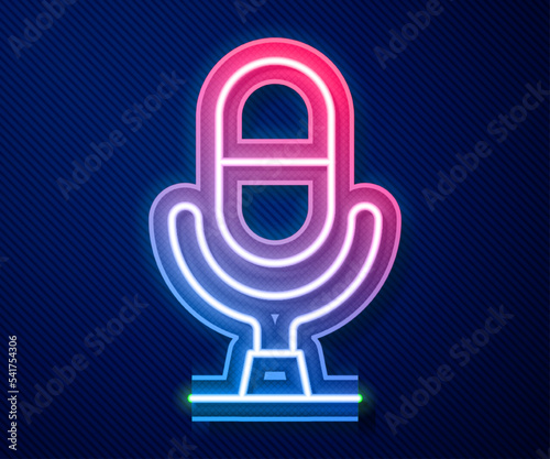 Glowing neon line Microphone voice device icon isolated on blue background. Microphone interpreter and alphabet letters. Vector