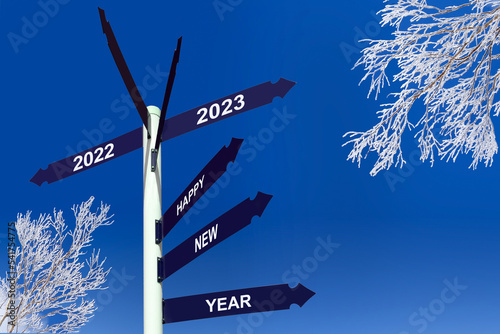 Happy new year 2023 on direction panels, snowy trees, winter greetings photo